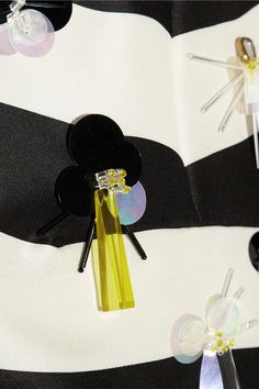 mickey mouse hair clips are attached to a black and white striped dress with yellow accents