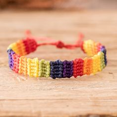 a multicolored bracelet on a wooden table