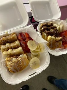 two plastic containers filled with bananas, strawberries and other foods on top of each other