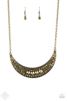 Varying in size, row after row of golden aurum rhinestones are encrusted along the front of a studded crescent moon brass frame, creating a glittery statement below the collar. Features an adjustable clasp closure. Sold as one individual necklace. Includes one pair of matching earrings. Paparazzi Fashion, Magnificent Mile, Trending Necklaces, Paparazzi Accessories, Brass Necklace, Paparazzi Jewelry, Short Necklace, Moon Child, Brass Frame