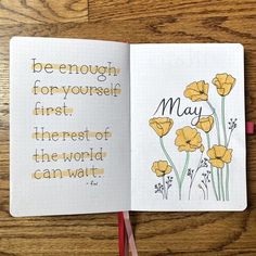 an open notebook with yellow flowers and the words may written in cursive writing