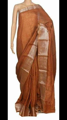 Linen sarees are always in demand.This handwoven Light Brown linen saree give you a unique style.The color is so vibrant that you are going to love it.Linen sarees are breathable,light weight and easy to drape. Fabric: Linen by linen  Thread count:100 count Saree Color: Light Brown  Occasion: Casual/Formal Saree length:5.50 mtr Blouse:Running, 1 mtr Custom Stitching: Available upon request Saree Embroidery: Available upon request Blouse Stitching: Available upon request Shipping: 7 to 10 busines Linen Dupatta For Festivals, Brown Raw Silk Saree For Festivals, Wedding Linen Saree With Handloom Detail, Brown Raw Silk Saree, Traditional Linen Saree With Zari Work, Traditional Linen Saree With Cutdana, Festive Brown Handloom Saree, Brown Handloom Chanderi Saree, Metallic Linen Saree