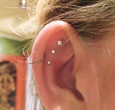 a close up of a person with a piercing on their ear