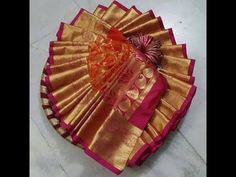 an orange and pink fan sitting on top of a floor