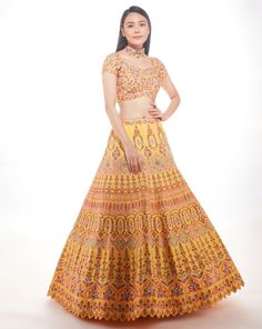 A yellow silk lehenga with fine multi-hued resham embroidery with a touch of sequins and glass beads paired with a matching blouse and mauve pink net dupatta From Chamee and Palak 's The Wedding Edit collectionDELIVERY TIMEPlease allow 8-12 weeks for your outfit to arrive.FABRIC DETAILSSilk And NetProfessional cleaning only. Yellow Silk Lehenga, Wedding Edit, Resham Embroidery, Resham Work, Vacuum Storage, Yellow Silk, Sequence Work, Fashion Hacks, Silk Lehenga