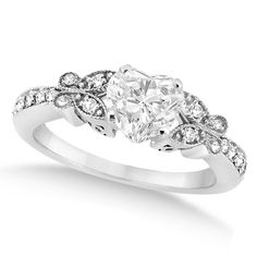 a white gold ring with an oval cut diamond and pave set diamonds on the sides