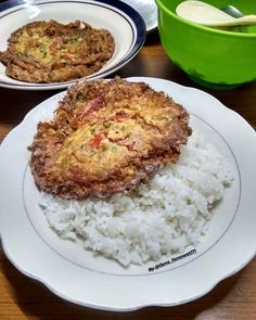 two plates with food on them sitting on a table