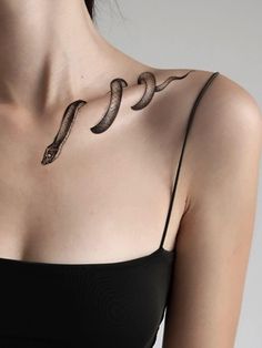 a woman with a snake tattoo on her chest