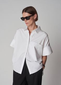 A precisely tailored yet easy-fitting short-sleeved cotton shirt. It can be worn effortlessly untucked or elegantly tucked into a pencil skirt where cinched volume can create the most alluring shapes. Hidden placket at center front. 100% Cotton 1703LCSP-CORE White True to size. See Size Guide in dropdown. Model is 5'9" 32" bust and wears a size Small. Oxford Comma, Poplin Top, Maxi Shirts, Linen Blend Pants, Leather Midi Skirt, Maxi Shirt Dress, Long Sleeve Sweater Dress, Wool Pants, Poplin Shirt