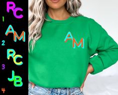 Elevate your wardrobe with our custom-designed Printed Block Font Neon Monogram Crewneck Sweatshirt! This stylish and cozy sweatshirt is the perfect canvas for your unique monogram, making it a fantastic gift for moms, a thoughtful Mother's Day surprise, a delightful holiday present, a trendy bachelorette proposal, or a heartfelt Valentine's Day gesture. 🎨 Choose Your Font Combo: Select from four chic font combinations to create a personalized monogram that reflects your style. The block font adds a modern touch, while the vibrant neon colors make a bold statement. It's a fashion-forward piece that stands out in any crowd. 🌈 Neon Color Palette: Our neon color options will add a pop of excitement to your wardrobe. Choose from a spectrum of vibrant hues that bring life to your monogram, ma Casual Green Customizable Sweatshirt, Customizable Green Long Sleeve Sweatshirt, Customizable Long Sleeve Green Sweatshirt, Custom Text Casual Sweatshirt For Fall, Casual Custom Text Sweatshirt For Fall, Casual Sweatshirt With Custom Text, Casual Fall Sweatshirt With Custom Text, Green Branded Sweatshirt For Fall, Green Branding Sweatshirt For Fall