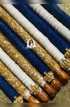 there are many different types of candles on the table with gold and white frosting