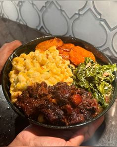 a person holding a bowl full of food