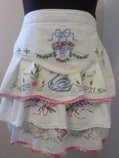 a woman's white skirt with pink trimmings and flowers on the bottom