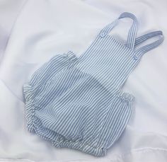 Ultimate hot weather unisex attire for Baby! Classic style summer sunsuit/romper. Lightweight cotton blue/white striped seersucker fabric is almost weightless while making Baby look VERY cool and put together! Machine wash and dry. Cotton material was pre-washed/dried so it will stay the same size you bought after washing/drying at home. SIZES: 3-6 mo, 6-12 mo Summer Cotton Onesie, Blue Bubble Romper For Summer, Casual Blue Onesie For Summer, Casual Blue Summer Onesie, Casual Blue Bubble Romper For Summer, Striped Cotton Jumpsuits And Rompers For Summer, Summer Striped Cotton Jumpsuits And Rompers, Light Blue Cotton Jumpsuits And Rompers For Summer, Light Blue Cotton Bubble Romper For Summer