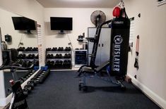 a home gym with several exercise equipment