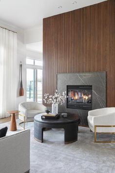 a living room with two couches, a coffee table and a fireplace in it