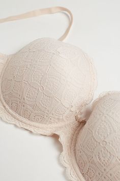 Irina balconette bra with underwire and lightly padded cups with interior cotton lining. The cups are higher on the sides for a snug effect that helps emphasize the décolleté. Fully adjustable elastic straps. The underband is lined in tulle and the closure is two hooks high and four hooks wide. Made in soft and comfortable stretch lace that features a geometric design and romantic ruffles. This bra emphasizes the décolleté, guaranteeing optimal support and creating a refined and sensual style. Feminine Underwire Nursing Bra With Padded Cups, Feminine Underwire Bra With Padded Cups, Feminine Push-up Bra With Removable Cups, Balconette Bra With Removable Pads, Feminine Full Cup Bra With Padded Cups, Feminine Padded Underwire Bra, Feminine Full Cup Bra With Removable Cups, Classic Bra With Removable Cups And Underwire, Fitted Balconette Bra With Removable Pads