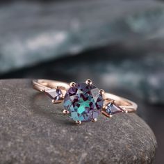 "Vintage Alexandrite Ring, , Engagement Ring, unique marriage proposal ring, June Birthstone ring, Anniversary Gift for Her, promise ring 💎 Exceptional 1 ct Alexandrite gemstone wedding/engagement ring mastered by our skillful craftsmen. Our bestseller item with reviewed over 100 times with 5 stars. 💎 The precious piece will be delivered in an elegant gift box. 💎 Alexandrite is a stone that holds great balancing properties that harmonize your physical self with your emotional and spiritual being. The stone is known to work with your crown chakra in order to initiate a process of emotional healing by leading you to the energies of \"LOVE\" and healing. *Primary Stone: Lab Alexandrite  *Stone Color: Purple *Stone Shape: Round *Stone Size: 6 mm  *Secondary Stone Type: CZ Diamond *Stone Siz Alexandrite And Peridot Ring, June Birthstone Ring Alexandrite, October Birthstone Engagement Ring, June Birthstone Engagement Ring, Alexandrite Engagement Ring Vintage, Alexandrite Ring Engagement, Rainbow Topaz Ring, Ring 3 Stone, Birthstone Engagement Rings