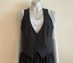 "Women's Vest Black Striped Vest Black Womens Waistcoat Steampunk Formal Fitted Victorian Renaissance Baroque Edwardian Medium Size Label size: 38/40 EUR,12 UK Measurements (lying flat): Length(back): 19.5\"/ 49.5 cm Pit to pit: 19\"/ 48 cm Waist: 17.5\"/ 44.5 cm Please check measurements to insure a proper fit. Remember to allow yourself some extra room for movement. You can compare these with something from your closet that fits you well. Condition: great Vintage Condition Material: polyester, Black Gothic Vest For Fall, Steampunk Black Vest For Fall, Black Fitted Steampunk Vest, Punk Style Fitted Vest For Fall, Fitted Steampunk Vest For Fall, Fitted Vest For Spring Alternative Fashion, Fitted Black Vest For Costume, Black Fitted Vest For Alternative Fashion, Fitted Black Vest For Alternative Fashion