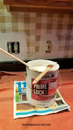 a paint bucket with a wooden stick in it