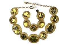 Vintage 1980's YVES SAINT LAURENT, made in France by Robert Goossens, byzantine style, irregular amber resin cabochons alternating oval and circular medallions, on the necklace and with circular medallions for the bracelet, with gold plated metal. Necklace adjustable hook closure, with signature YSL, and bracelet signed on the back in one of the medallions. CONDITION: Excellent DIMENSIONS: Necklace: Height: 4,8cm / Total Length: 57cm Bracelet: Height: 3,8cm / Total Length: 20cm More vintage item Gold Vintage Cabochons, Vintage Oval Gold Cabochons, Formal Gold Lucite Jewelry, Vintage Yellow Jewelry With Cabochon, Vintage Yellow Cabochon Jewelry, Saint Laurent Vintage, Amber Resin, Heart Pocket, Necklace And Bracelet Set