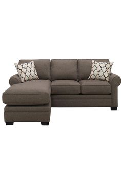 a sectional couch with pillows on it