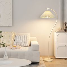 a living room with a white couch and lamp