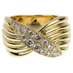 Imagine a stunning creation from the esteemed Van Cleef & Arpels, a Vintage Diamond Yellow Gold Cocktail Ring that exudes sophistication and timeless elegance. This masterpiece features an 18k yellow gold band, meticulously crafted to embody both strength and grace. The band itself is a work of art banded rows of polished gold that glows with the warm luster of yellow gold, evoking a sense of luxury and exclusivity. The ring's crowning glory is its exquisite bow-shaped motif, a signature design that adds a touch of whimsical charm to its opulent character. This motif is not just a mere decorative element; it's a showcase of Van Cleef & Arpels' mastery in jewelry design, blending creativity with technical prowess. Yellow Gold Cocktail Ring, Van Cleef & Arpels, Vintage Cocktail Ring, Van Cleef And Arpels, Gold Cocktail Ring, Vintage Diamond Rings, Gold Cocktail, Charm Rings, Van Cleef Arpels