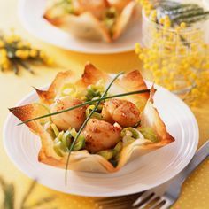 a white plate topped with scallops and vegetables