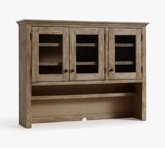 a wooden cabinet with glass doors on the top and bottom shelf, against a white background