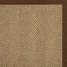 a brown and tan area rug with a checkered design on the bottom half of it