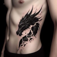 a man with a black dragon tattoo on his stomach and chest is posing for the camera