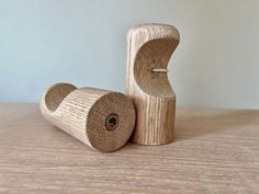 a small wooden object sitting on top of a wooden table next to another item that is made out of wood