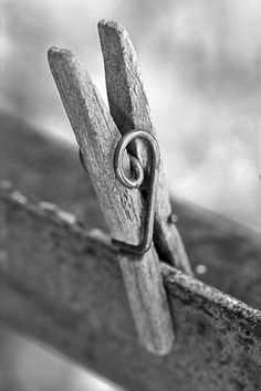 an old pair of scissors sitting on top of a piece of wood