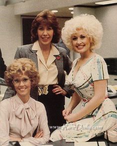 three women are posing for the camera in an office