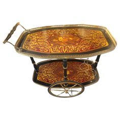 an ornately decorated serving tray on wheels