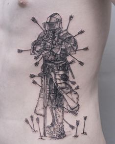 a man's back with an arrow and knight tattoo on his side, which has arrows pointing to the right