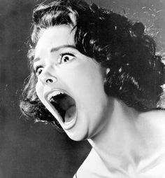 an old black and white photo of a woman screaming