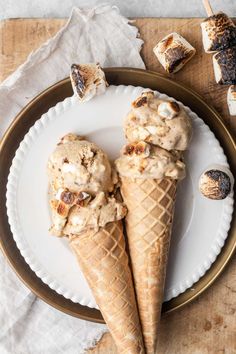 two ice cream cones are on a plate