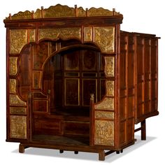 an ornate wooden cabinet with carved doors