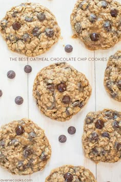 cookies with chocolate chips and oats laid out on a wooden table, ready to be eaten