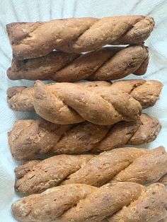 several braided breads sitting on top of a white paper towel next to each other