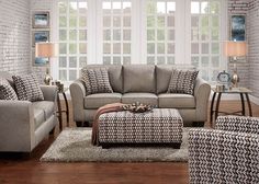 a living room with two couches and a coffee table in front of a window