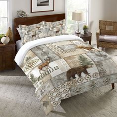 a bed in a bedroom with an animal themed comforter