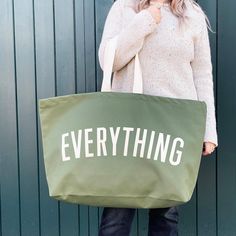 The original, and your favourite, EVERYTHING oversized tote, now available in smart olive green canvas. Our extra large canvas tote bags are REALLY useful. The perfect oversized tote for the pool, school run, beach trips, weekends away and your weekly shop. Actually they are pretty handy for everything!Our oversized Everything bag has been made from thick khaki canvas, screen printed by hand big and bold.Designed in our studio in Saffron Walden and lovingly handmade in the UK using exceptionally fine materials. Complimentary handwritten gift notes available! Made in the UK 15oz thick olive green canvas Deep flat base Screen printed in off-white Mid-length handles 730mm by 440mm by 170mm (28¾ by 17½ by 6¾ inches) Extra Large Tote Bags, Saffron Walden, Gym Kit, Extra Large Canvas, Oversized Tote Bag, Oversized Tote, Big Bag, Changing Bag, Travel Collection