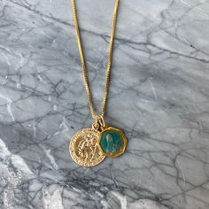 Pendant Details Pendant 1: Saint Christopher Size: 20mm by 20mm Material: 14k Gold Filled Pendant 2: Vintage Saint Therese of Lisieux Size: 15mm by 15mm Material: Two-Toned Blue Enamel Chain Details Material: 14K Gold Filled Thickness: 1mm Type: Box Chain Turquoise Coin Pendant Jewelry As Gift, Blue Coin Pendant Jewelry For Gifts, Blue Coin Pendant Jewelry As Gift, Gold Jewelry With Coin Pendant For May Birthstone, Gold Engraved Charm Necklace For May Birthstone, Green Coin Pendant Jewelry As Gift, Green Coin Pendant Jewelry For Gift, Saint Therese, St Christopher Necklace