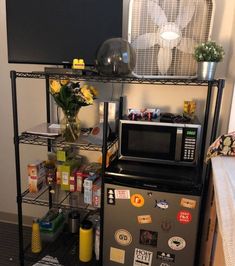 a microwave oven sitting on top of a metal shelf