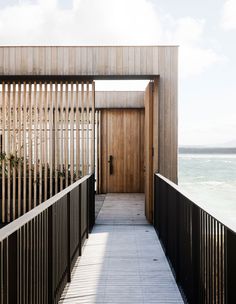 a wooden walkway leading to an open door