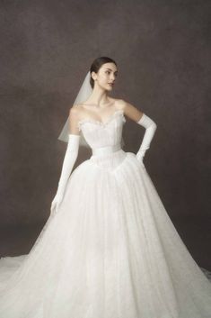 a woman in a white wedding dress and gloves