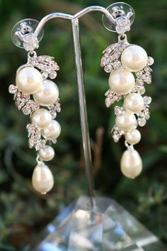 "Simply Chic.These earrings will sure make a big statment on your wedding day. Trinkling pearls surrounded with crystal petals and finished with a pear shape swarovski pearls .They are about 2 1/2 \" long. Matching bracelet available at this link https://www.etsy.com/listing/270957298/petals-and-leaves-rhinestone-crystal?ref=shop_home_active_1" Wedding Cuff Bracelet, Wedding Earrings Chandelier, Pearl Bracelet Wedding, Vintage Wedding Jewelry, Wedding Earring, Pearl Bridal Jewelry, Bridal Earrings Drop, Pearl Earrings Wedding, Bridal Earrings Pearl